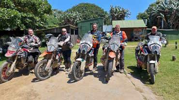 Adventure bike riders posing with their bikes outside a bnb in the Eastern Cape